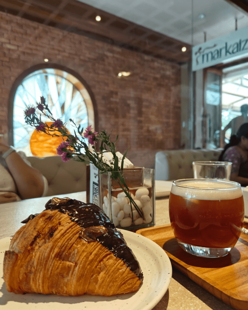 Chocolate walnut fudge croissant and peach iced tea at Markaiz, lonavala